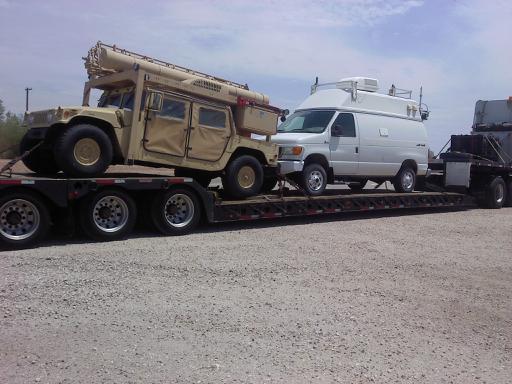 humv and van on rgn trailer truck transport photo